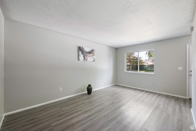 558 N Redwood Rd Unit 3, Salt Lake City, UT 84116 - spare room with a textured ceiling and wood finished floors