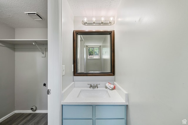 558 N Redwood Rd Unit 3, Salt Lake City, UT 84116 - bathroom featuring wood finished floors, vanity, and a textured ceiling