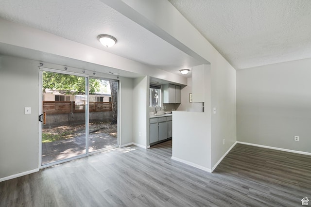 558 N Redwood Rd Unit 3, Salt Lake City, UT 84116 - unfurnished living room with a textured ceiling and wood finished floors