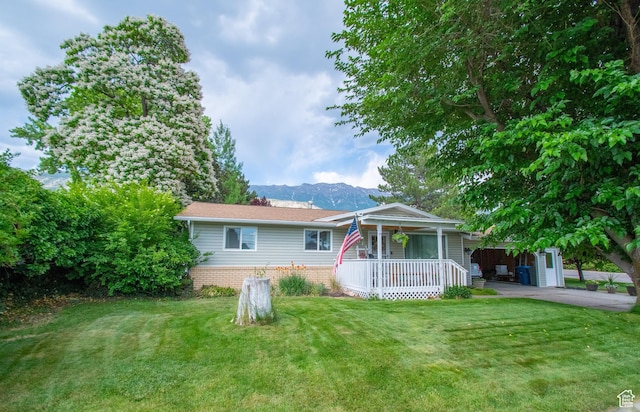 651 S Locust Ave, Pleasant Grove, UT 84062 - view of front of home with a porch, a front lawn, a mountain view, and brick siding