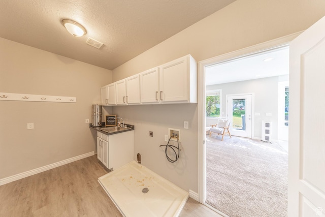 1320 E Canberra Dr, Lindon, UT 84042 - laundry area with washer hookup, electric dryer hookup, cabinet space, light wood-type flooring, and a textured ceiling