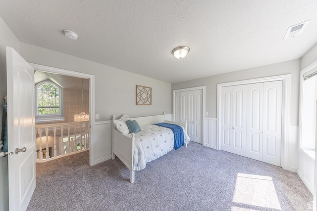 1320 E Canberra Dr, Lindon, UT 84042 - carpeted bedroom with two closets and a textured ceiling