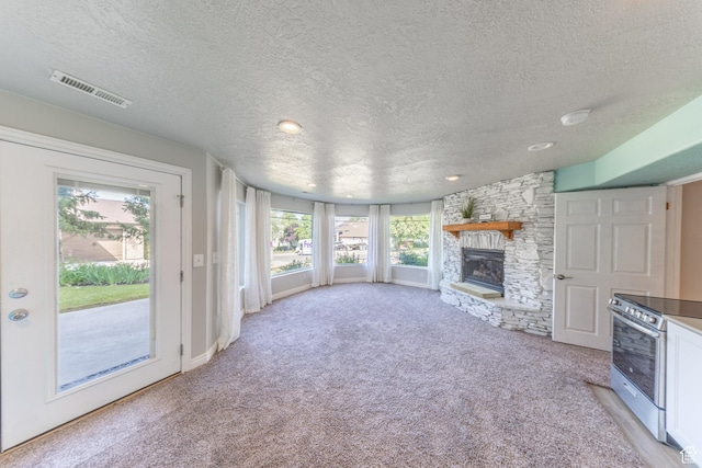 1320 E Canberra Dr, Lindon, UT 84042 - unfurnished living room featuring a textured ceiling, light carpet, a stone fireplace, and recessed lighting