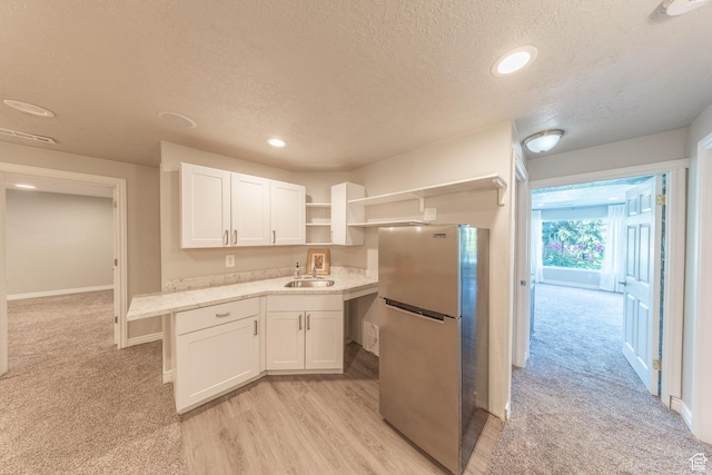 1320 E Canberra Dr, Lindon, UT 84042 - kitchen featuring freestanding refrigerator, open shelves, a textured ceiling, white cabinets, and light carpet
