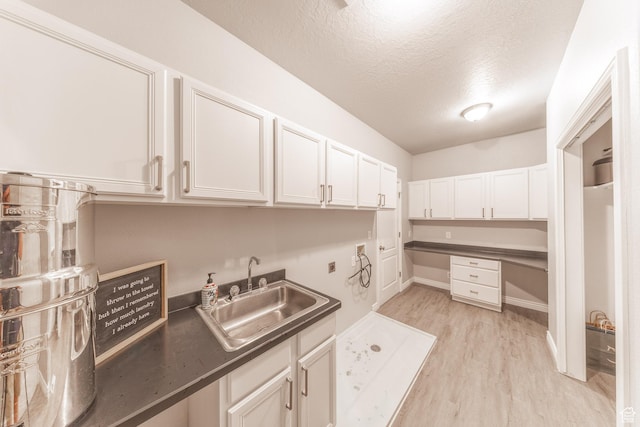 1320 E Canberra Dr, Lindon, UT 84042 - washroom with a textured ceiling, light wood finished floors, cabinet space, washer hookup, and bar with sink