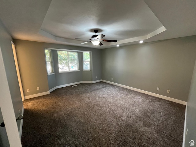 7886 S Abercrombie Ln, West Jordan, UT 84088 - empty room with a tray ceiling, ceiling fan, and dark carpet