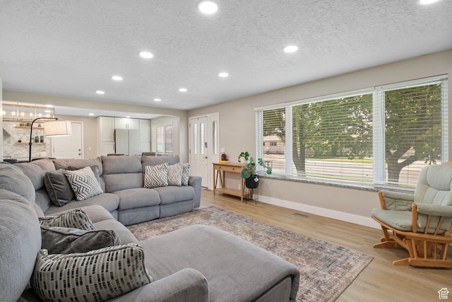 4663 S 2030 W, Taylorsville, UT 84129 - living area with a textured ceiling, light wood-style flooring, recessed lighting, and a chandelier