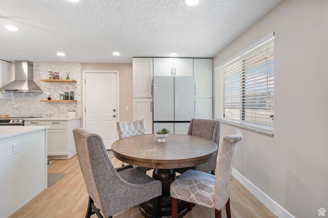 4663 S 2030 W, Taylorsville, UT 84129 - dining area with light wood-style floors, a textured ceiling, and recessed lighting