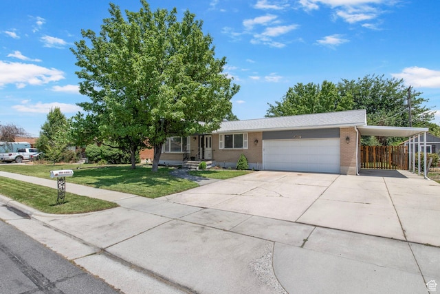4663 S 2030 W, Taylorsville, UT 84129 - view of front of property featuring brick siding, an attached garage, and driveway
