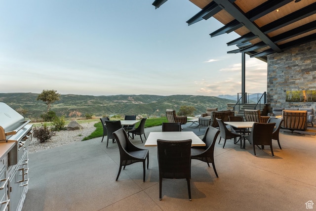 9156 N Sleeping Rock Cir, Kamas, UT 84036 - view of patio / terrace with outdoor dining area, a mountain view, and exterior kitchen