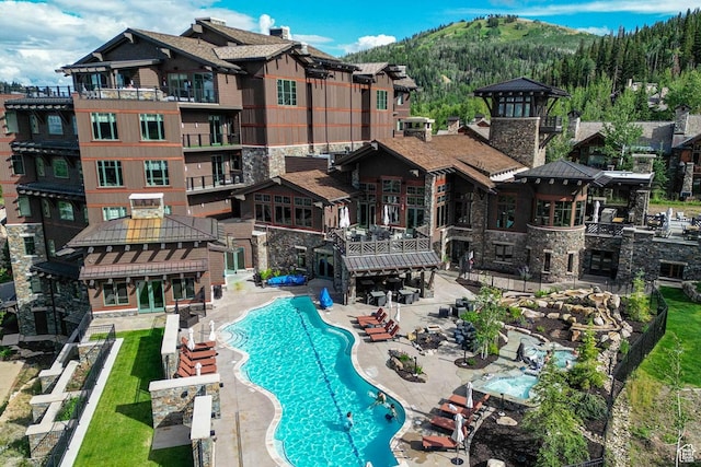 9156 N Sleeping Rock Cir, Kamas, UT 84036 - community pool with a mountain view and a patio area
