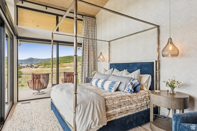 9156 N Sleeping Rock Cir, Kamas, UT 84036 - bedroom featuring wallpapered walls, a mountain view, access to outside, wood finished floors, and a high ceiling