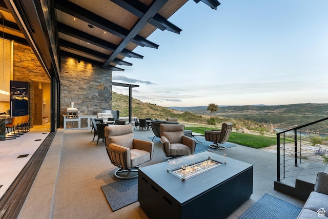 9156 N Sleeping Rock Cir, Kamas, UT 84036 - view of patio featuring a mountain view, an outdoor living space with a fire pit, and an outdoor kitchen