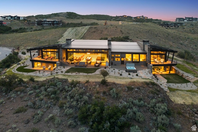 9156 N Sleeping Rock Cir, Kamas, UT 84036 - back of house featuring a chimney, a patio area, a standing seam roof, and a metal roof