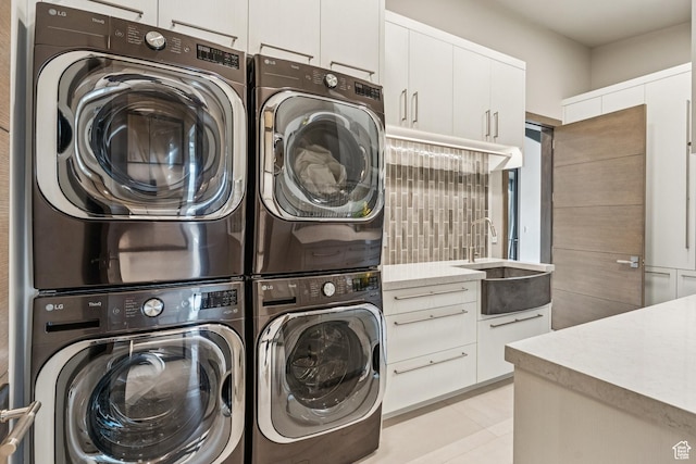 9156 N Sleeping Rock Cir, Kamas, UT 84036 - laundry area featuring stacked washer / dryer, cabinet space, and washer and dryer
