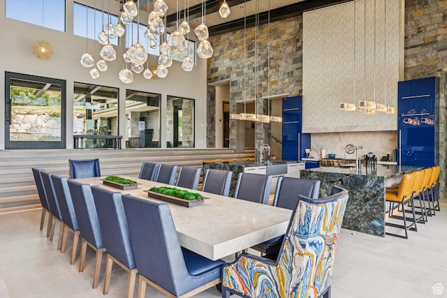 9156 N Sleeping Rock Cir, Kamas, UT 84036 - dining space with a towering ceiling, a chandelier, beamed ceiling, and finished concrete floors
