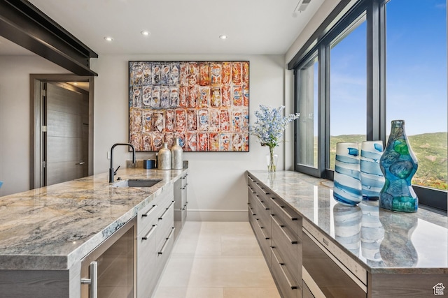 9156 N Sleeping Rock Cir, Kamas, UT 84036 - kitchen featuring beverage cooler, a peninsula, recessed lighting, light stone counters, and white cabinets