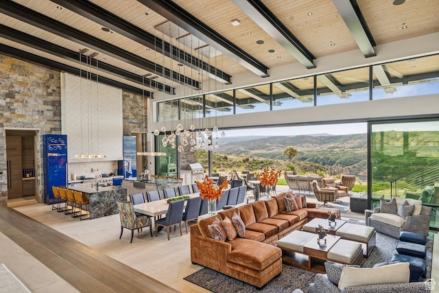 9156 N Sleeping Rock Cir, Kamas, UT 84036 - living area featuring light wood-style flooring, a wooden ceiling with exposed beams, a mountain view, and a towering ceiling