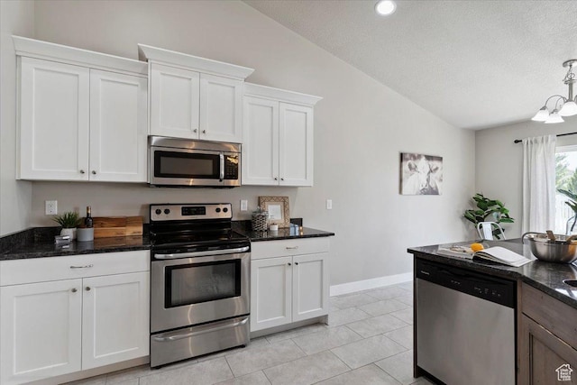 1592 E Maple Way S, Layton, UT 84040 - kitchen with appliances with stainless steel finishes, vaulted ceiling, a textured ceiling, white cabinets, and dark stone countertops