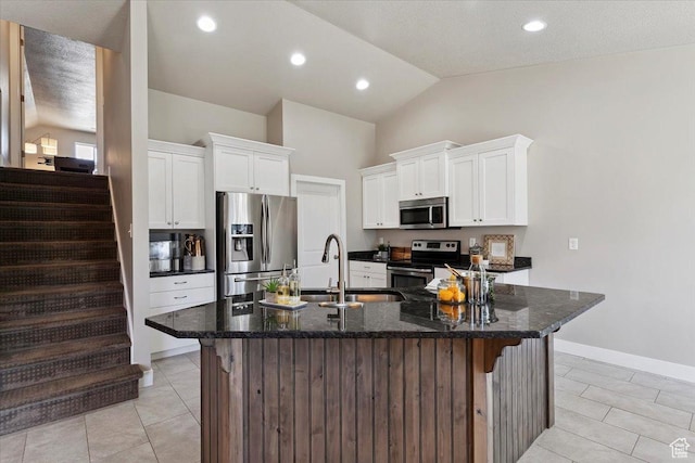 1592 E Maple Way S, Layton, UT 84040 - kitchen with stainless steel appliances, an island with sink, light tile patterned floors, white cabinetry, and high vaulted ceiling