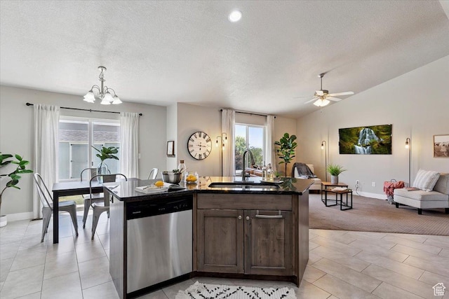 1592 E Maple Way S, Layton, UT 84040 - kitchen featuring stainless steel dishwasher, open floor plan, dark brown cabinets, an island with sink, and a textured ceiling