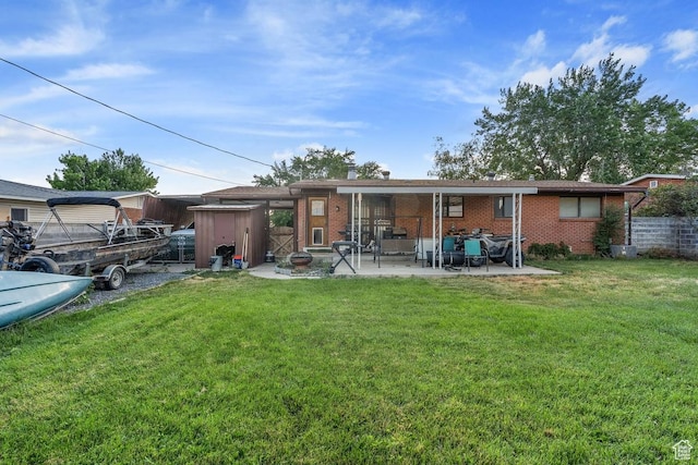 961 Hillview Rd, Brigham City, UT 84302 - back of house with brick siding, a patio, and a yard