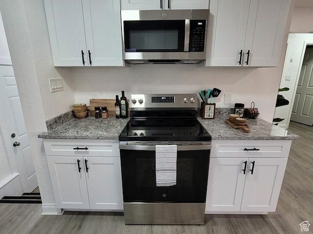 448 N 900 W, Salt Lake City, UT 84116 - kitchen with stainless steel appliances, light wood-style flooring, white cabinets, and light stone counters