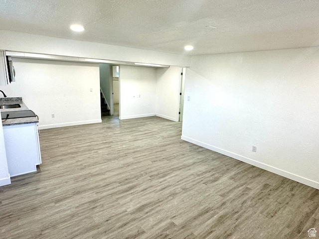 448 N 900 W, Salt Lake City, UT 84116 - finished below grade area with wood finished floors, stairway, a textured ceiling, and recessed lighting