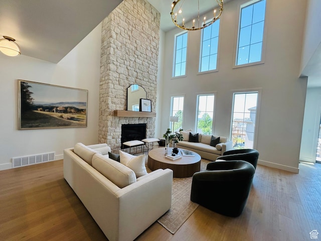 3868 N 475 E, North Ogden, UT 84414 - living area with a chandelier, wood finished floors, a fireplace, and a towering ceiling