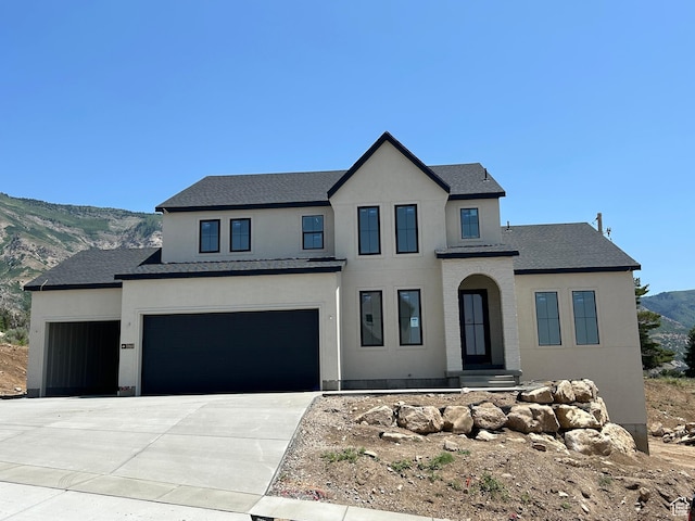 3868 N 475 E, North Ogden, UT 84414 - view of front facade featuring stucco siding, driveway, a mountain view, an attached garage, and a shingled roof