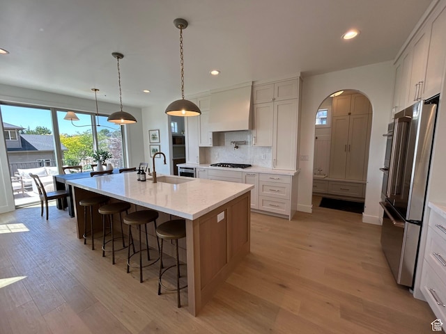3868 N 475 E, North Ogden, UT 84414 - kitchen with custom range hood, stainless steel appliances, light wood-style floors, recessed lighting, and backsplash