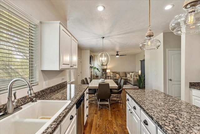 14618 S Gallatin Ln E, Draper, UT 84020 - kitchen with dishwasher, plenty of natural light, white cabinetry, dark wood finished floors, and a textured ceiling