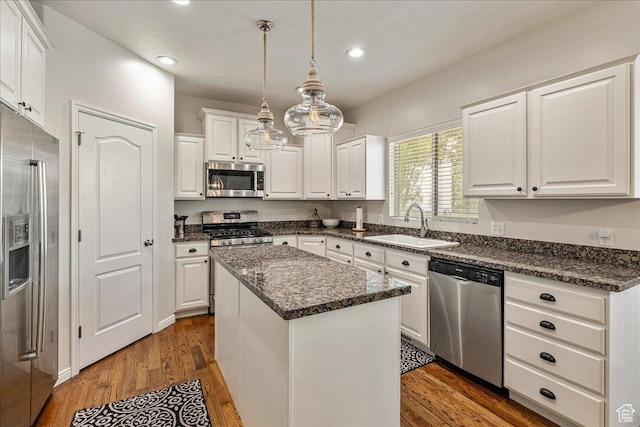 14618 S Gallatin Ln E, Draper, UT 84020 - kitchen with stainless steel appliances, white cabinets, a center island, recessed lighting, and dark wood finished floors