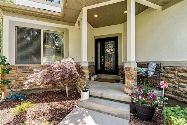 14618 S Gallatin Ln E, Draper, UT 84020 - doorway to property with stone siding, stucco siding, and a porch