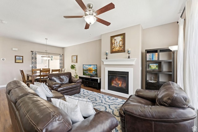 14616 S Auroral Way, Herriman, UT 84096 - living room with wood finished floors, a ceiling fan, and a glass covered fireplace