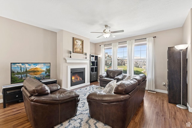 14616 S Auroral Way, Herriman, UT 84096 - living area with wood finished floors, ceiling fan, and a glass covered fireplace