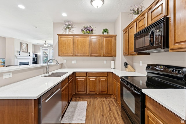 14616 S Auroral Way, Herriman, UT 84096 - kitchen featuring black appliances, wood finished floors, brown cabinets, ceiling fan, and recessed lighting