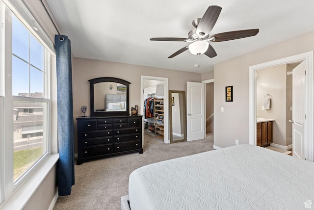14616 S Auroral Way, Herriman, UT 84096 - bedroom featuring a walk in closet, carpet, a closet, a ceiling fan, and connected bathroom