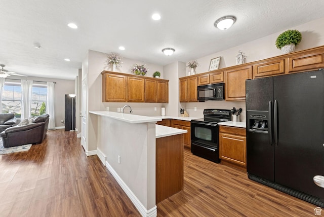 14616 S Auroral Way, Herriman, UT 84096 - kitchen with black appliances, brown cabinetry, dark wood finished floors, and recessed lighting