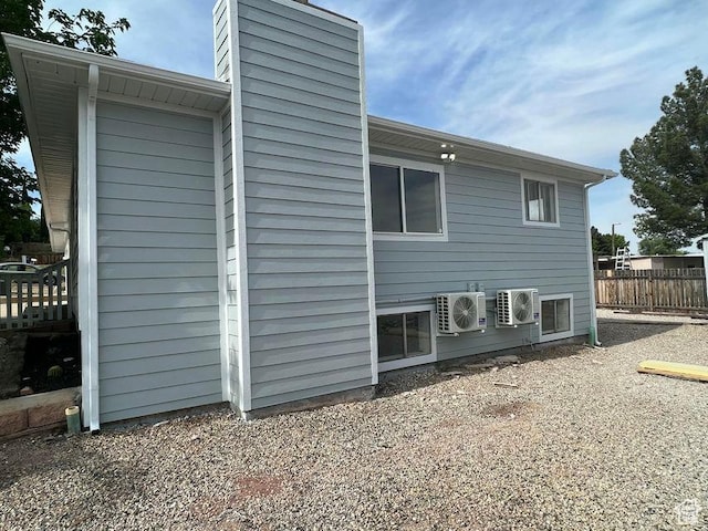 48 N Village Way, Washington, UT 84780 - view of side of home featuring a cooling unit and a chimney