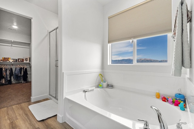 1385 N 680 W, Tooele, UT 84074 - full bath with a bath, a shower stall, a walk in closet, and wood finished floors