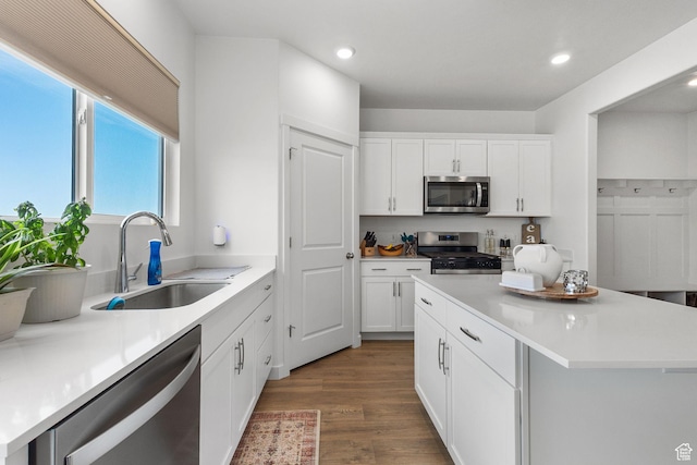 1385 N 680 W, Tooele, UT 84074 - kitchen featuring stainless steel appliances, recessed lighting, wood finished floors, white cabinetry, and a kitchen island