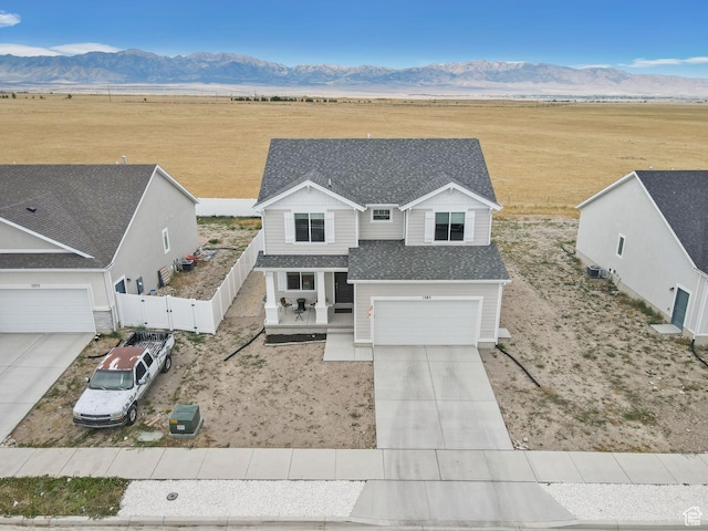 1385 N 680 W, Tooele, UT 84074 - view of front of house with a rural view, driveway, a mountain view, a gate, and a shingled roof