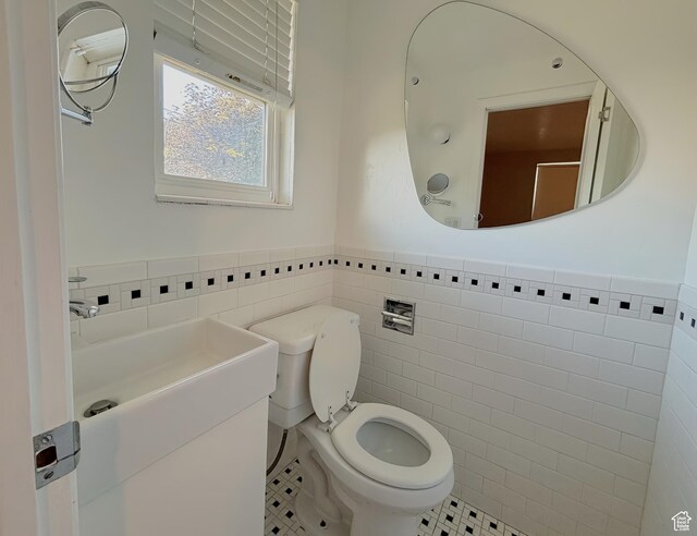 2057 E Castle Hill Ave, Cottonwood Heights, UT 84121 - half bathroom with tile walls, a wainscoted wall, tile patterned floors, and vanity