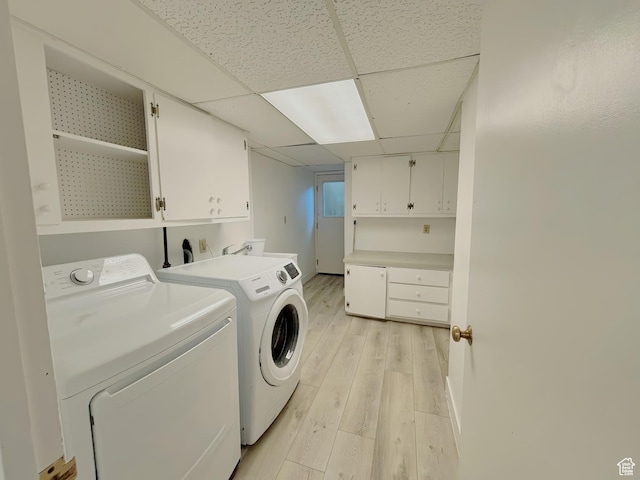 2057 E Castle Hill Ave, Cottonwood Heights, UT 84121 - laundry area featuring washing machine and dryer, cabinet space, and light wood-type flooring