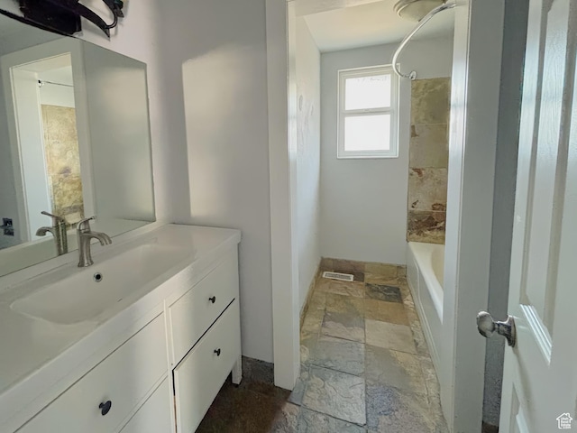 2057 E Castle Hill Ave, Cottonwood Heights, UT 84121 - bathroom with stone tile flooring, vanity, and  shower combination