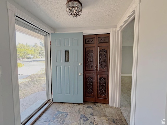 2057 E Castle Hill Ave, Cottonwood Heights, UT 84121 - foyer featuring a textured ceiling and light stone finish flooring