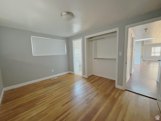 2057 E Castle Hill Ave, Cottonwood Heights, UT 84121 - unfurnished bedroom with a closet and wood finished floors