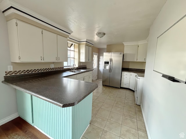 2057 E Castle Hill Ave, Cottonwood Heights, UT 84121 - kitchen with stainless steel refrigerator with ice dispenser, dark countertops, a peninsula, range, and white cabinetry