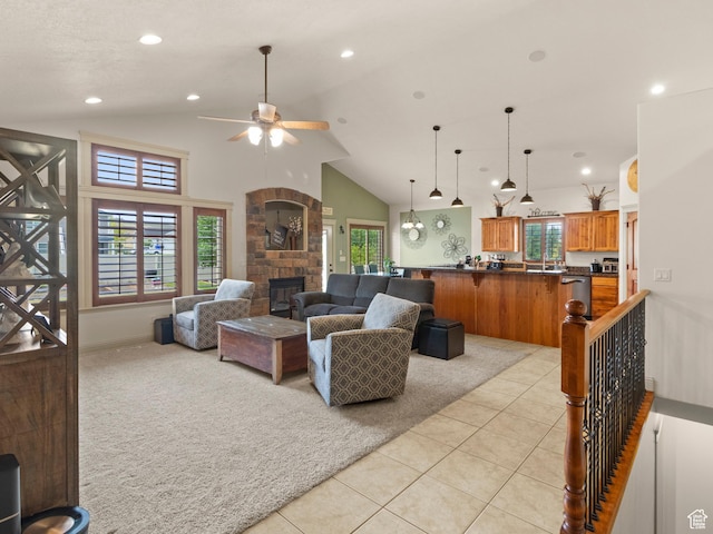 2618 W Mountain Rd, Tremonton, UT 84337 - living area featuring light tile patterned floors, a ceiling fan, a stone fireplace, light colored carpet, and recessed lighting